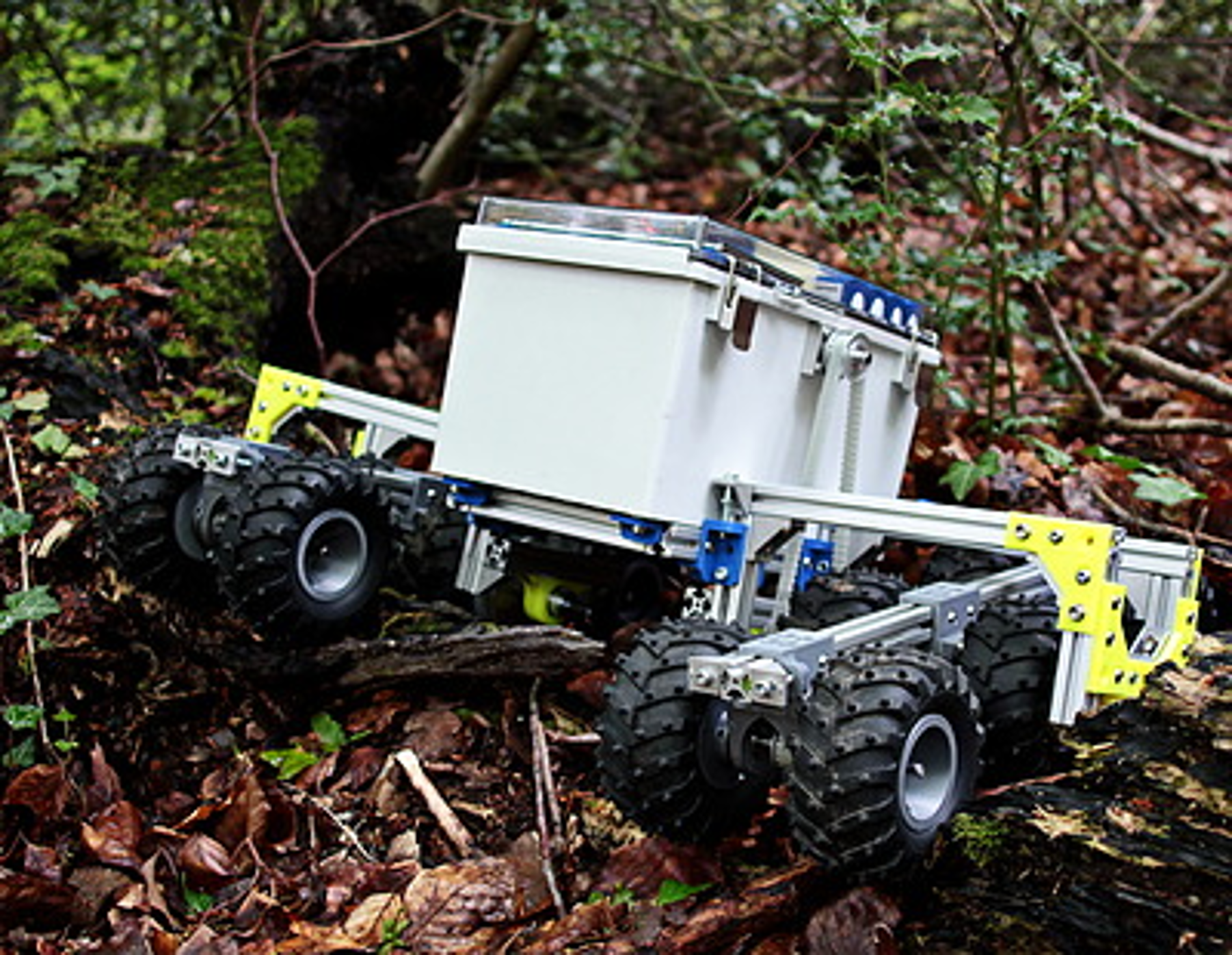 A robotic vehicle on the floor of a wooded area
