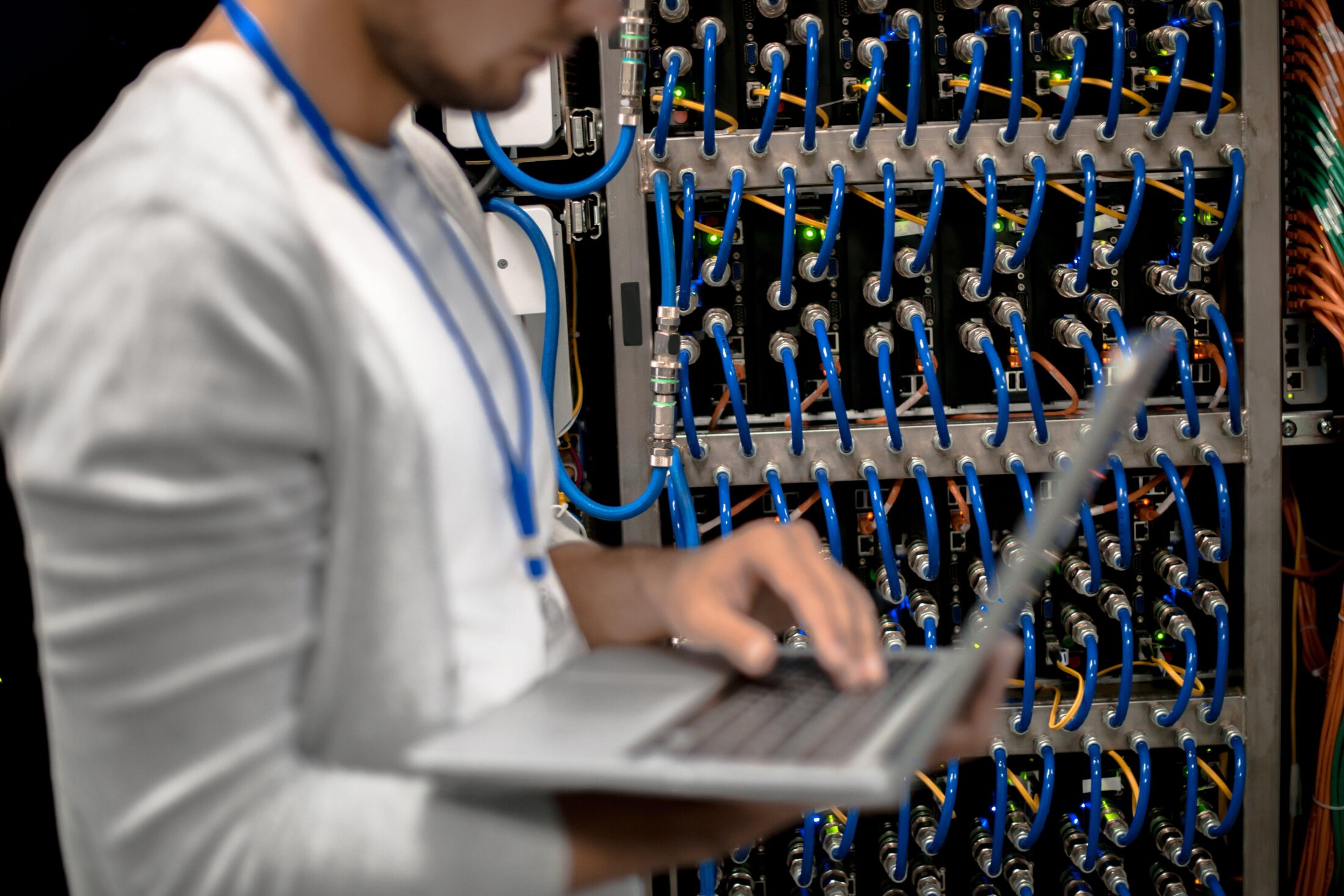 A person standing in front of a server cabinet