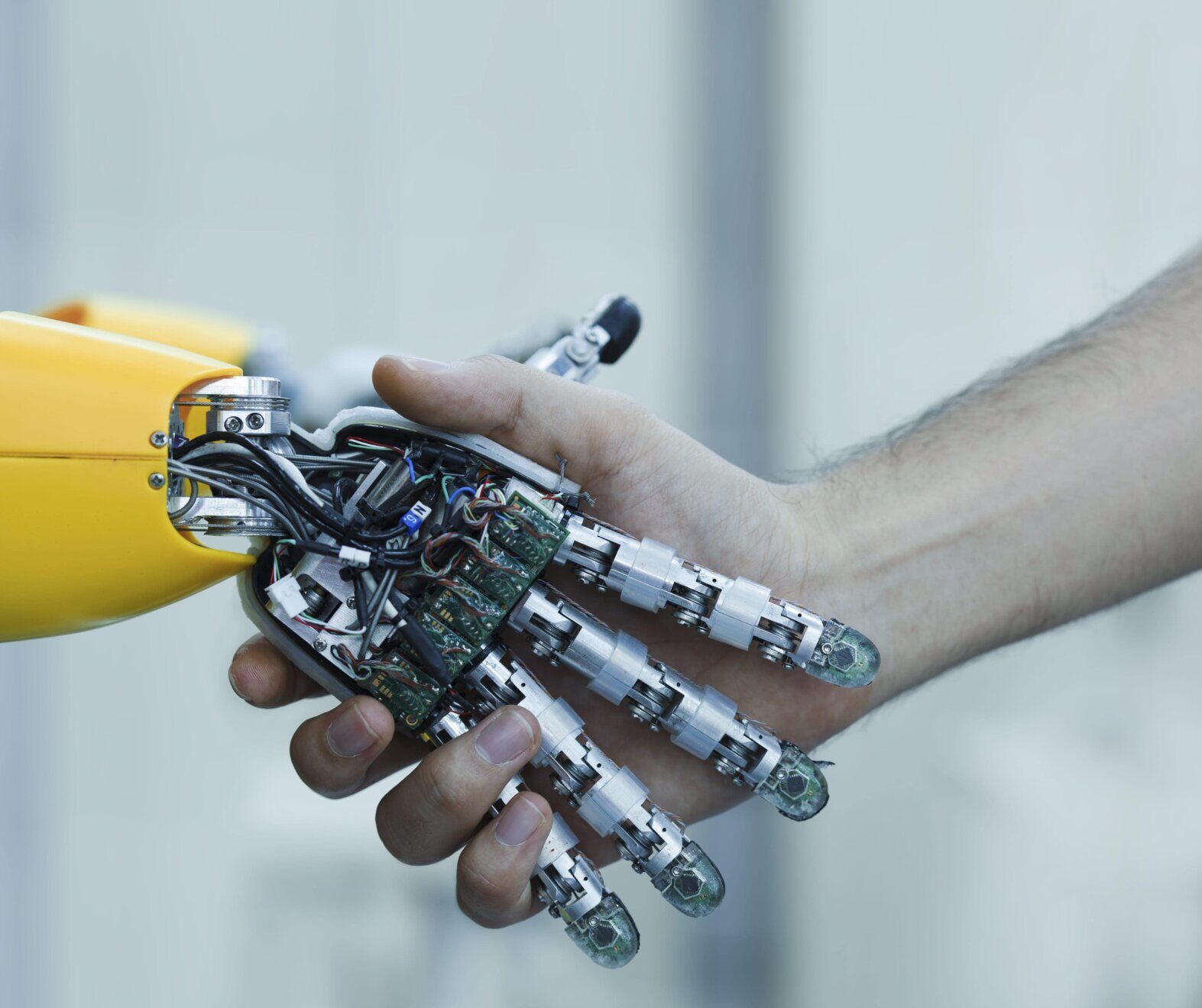 A person shaking hands with a robotic hand