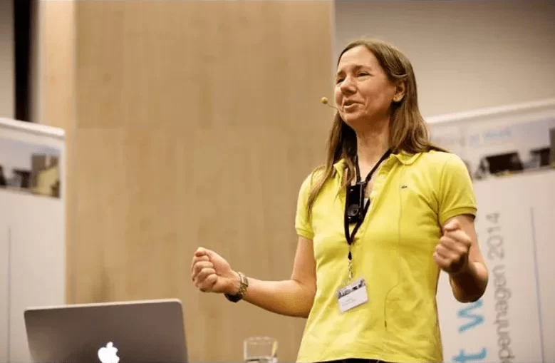 A member of ECS staff wearing a yellow top, delivers a lecture